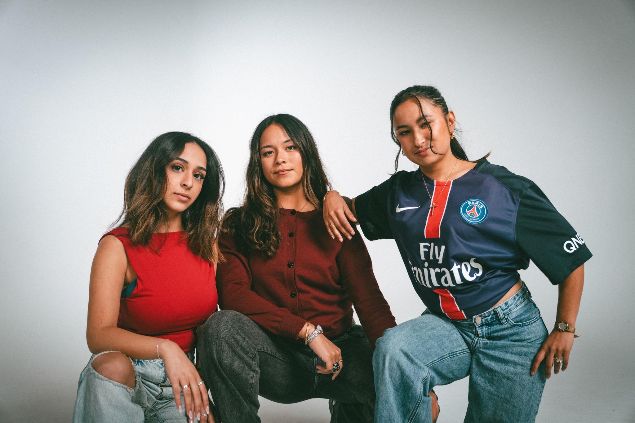 Three young women from GenJ sitting together in the studio